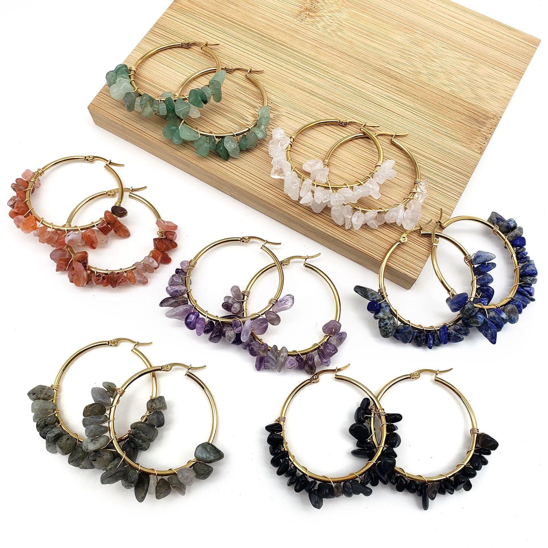 These earrings feature golden hoops paired with natural green stones, symbolizing the vitality and growth of nature. Green gemstones are often seen as symbols of balance and health, bringing a sense of inner peace, making them ideal for wearers looking to connect with nature's energy.