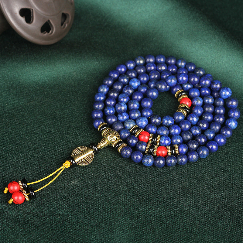 108-bead Lapis Lazuli mala with brass and black accents, crafted for meditation and spiritual grounding.