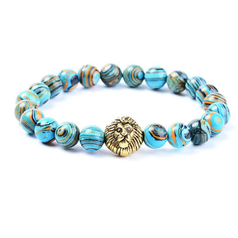 Turquoise and orange swirled gemstone bracelet with gold lion charm for strength and courage.