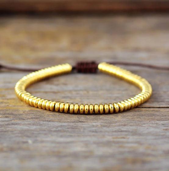 A complete view of the golden Tiger Eye stone bracelet, elegantly designed with a uniform arrangement of polished stones, exuding a sense of strength and prosperity.