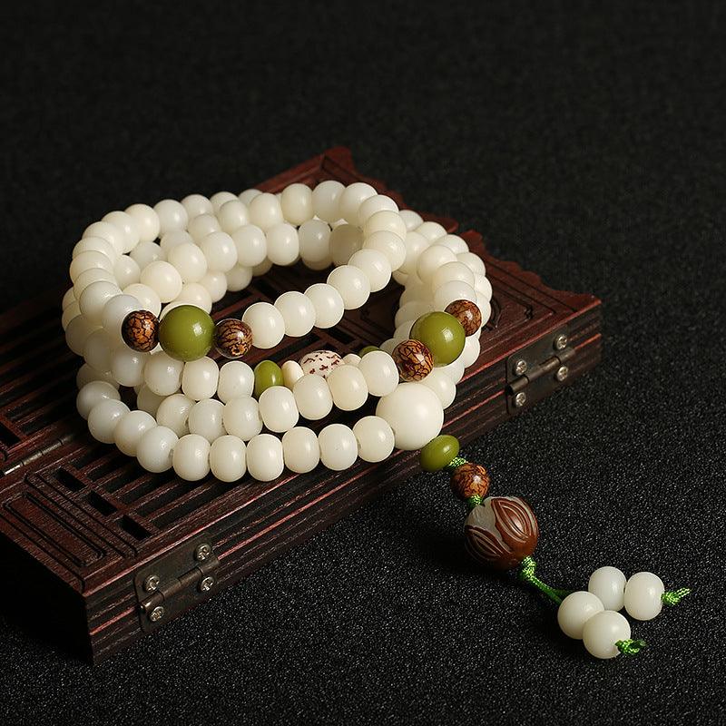 A complete view of the white jade Bodhi Mala beads, symbolizing purity and spiritual growth, perfectly arranged on a dark background to highlight its serene beauty.
