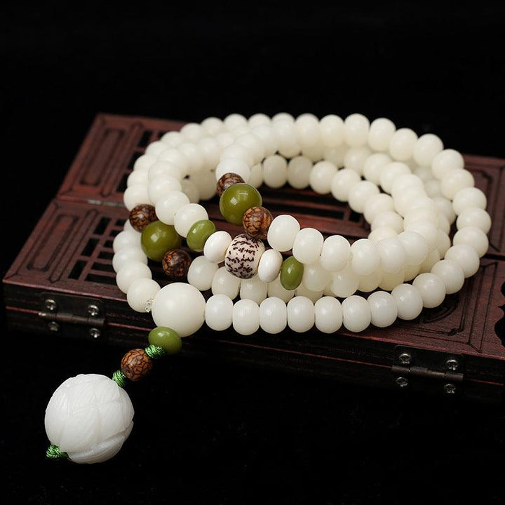 White Bodhi-style bead wrist mala laid out in a circle