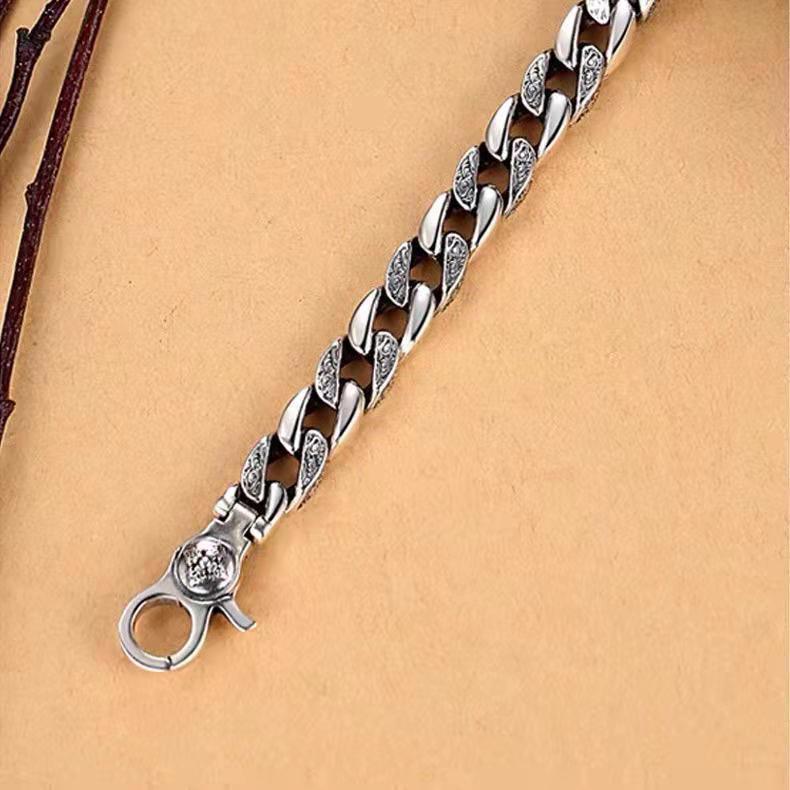 Angle view highlighting the engraved patterns on the bracelet, symbolizing protection and cultural heritage.