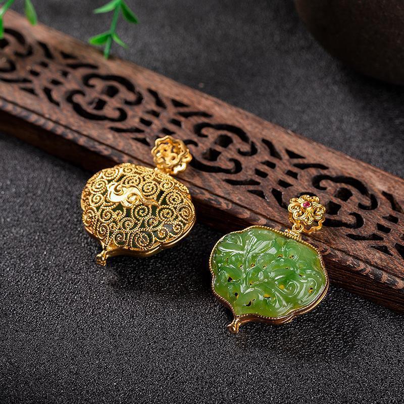 Beautifully crafted jade locket with floral engravings and gold detailing, showcasing traditional craftsmanship and elegance.