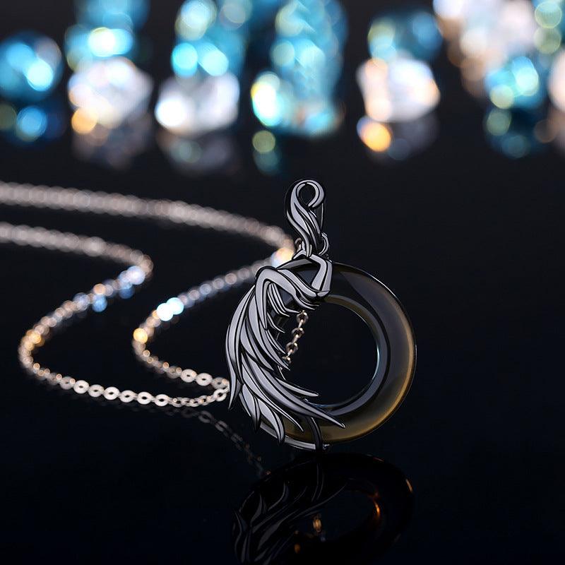 Black jade pendant with an artistic flowing figure design on a fine silver chain, exuding elegance and mystique.