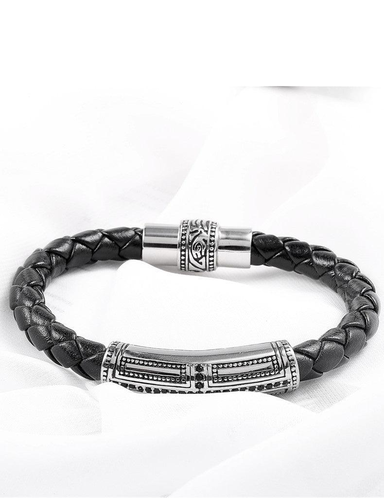 Black leather bracelet with an intricate magnetic clasp, easy to wear and secure for any occasion.