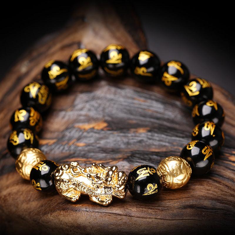 Black mantra bracelet featuring gold-plated Pixiu charm, with beads engraved with the Six-Word Mantra, symbolizing protection and prosperity.