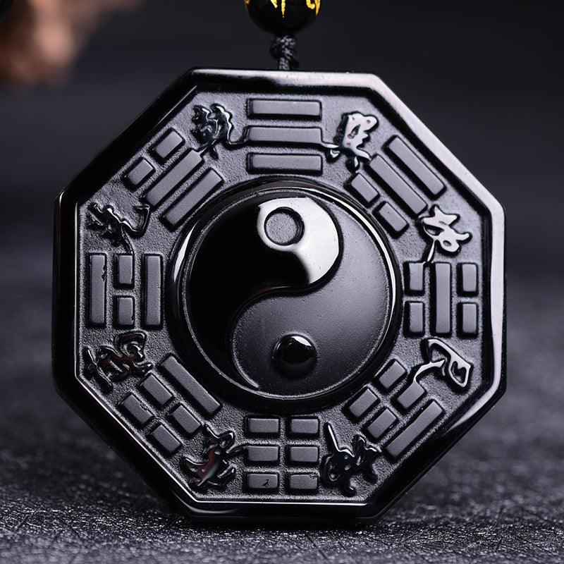 Black obsidian pendant featuring the Yin-Yang symbol and Bagua design, perfect for balancing energy and promoting harmony.