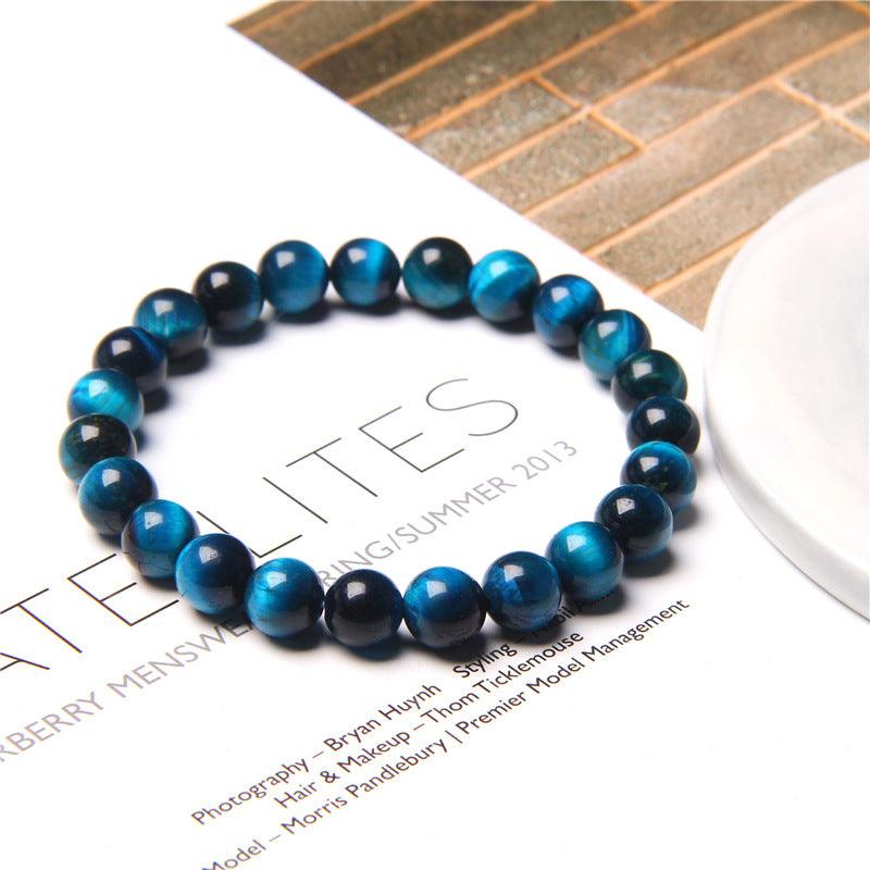 Blue tiger eye bead bracelet displayed on a modern backdrop, showcasing its rich colors and natural reflective quality, symbolizing protection and focus.