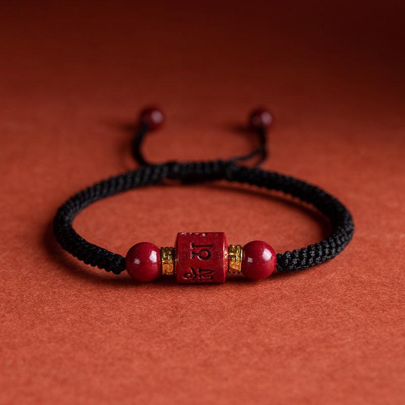 Cinnabar black rope bracelet with engraved Six-Word Mantra bead, symbolizing protection and peace. Ideal for daily spiritual support.