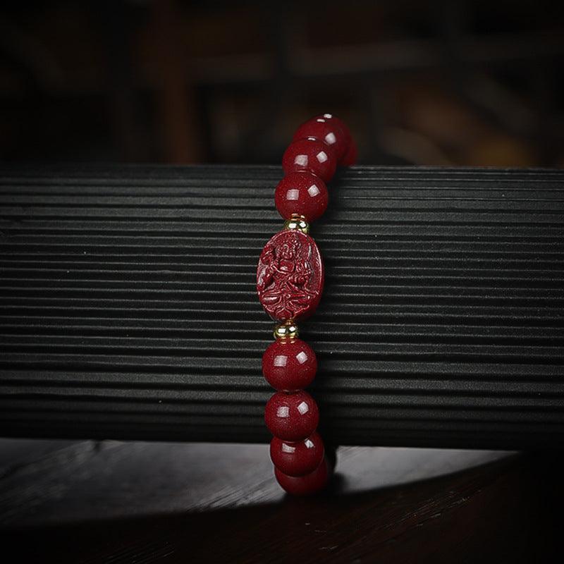 Cinnabar bracelet with a Buddha centerpiece, a symbol of luck and spiritual strength.