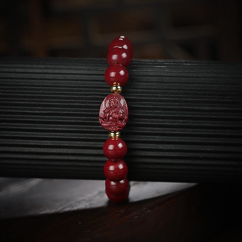 Cinnabar bracelet with a sacred Buddha bead, carrying blessings of peace and protection.