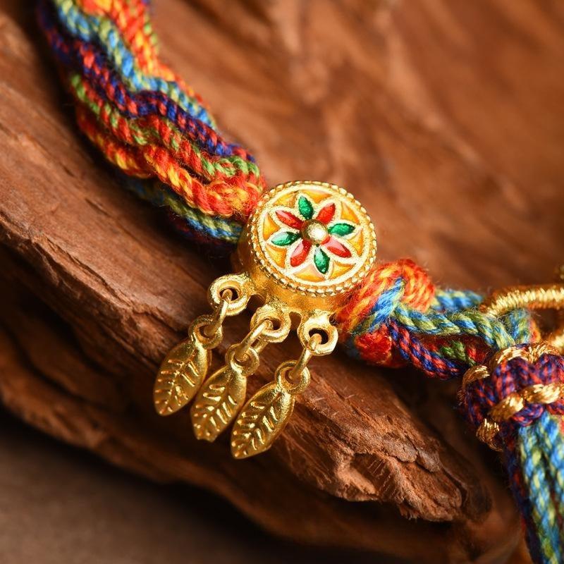 Close-up of leaf-shaped gold charms, representing growth, prosperity, and connection to nature.