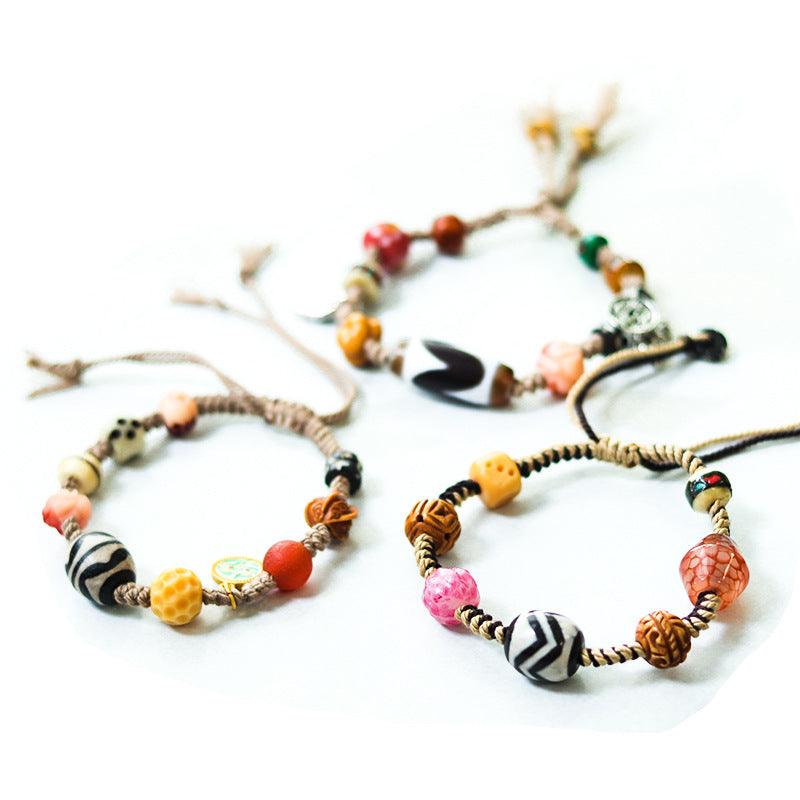 Close-up of mixed beads on the bracelets, highlighting the diverse textures and cultural motifs.