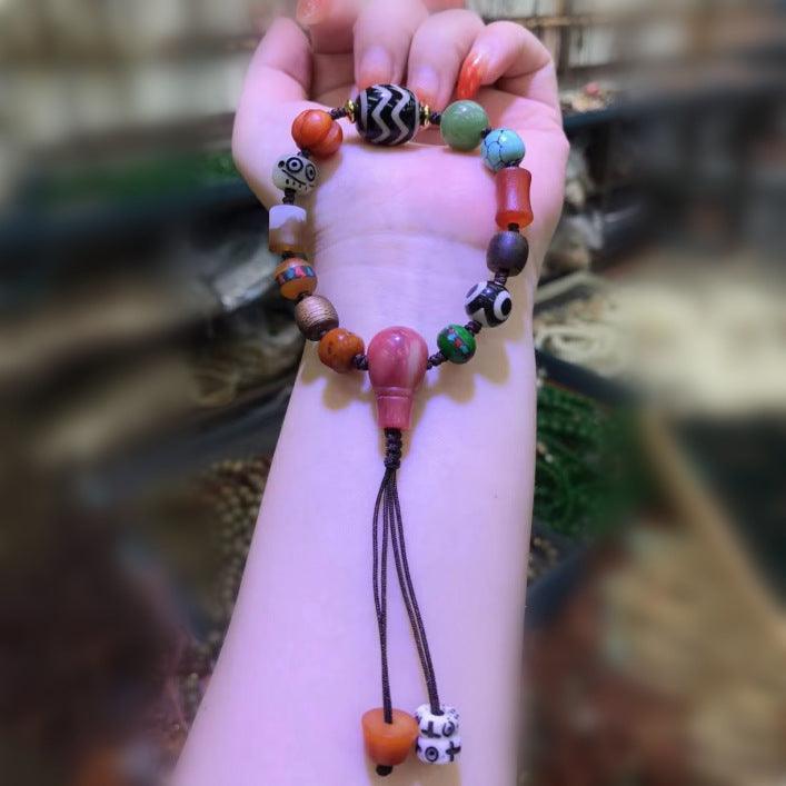 Close-up of skull-patterned bead, representing transformation and adding an edgy element to the design.