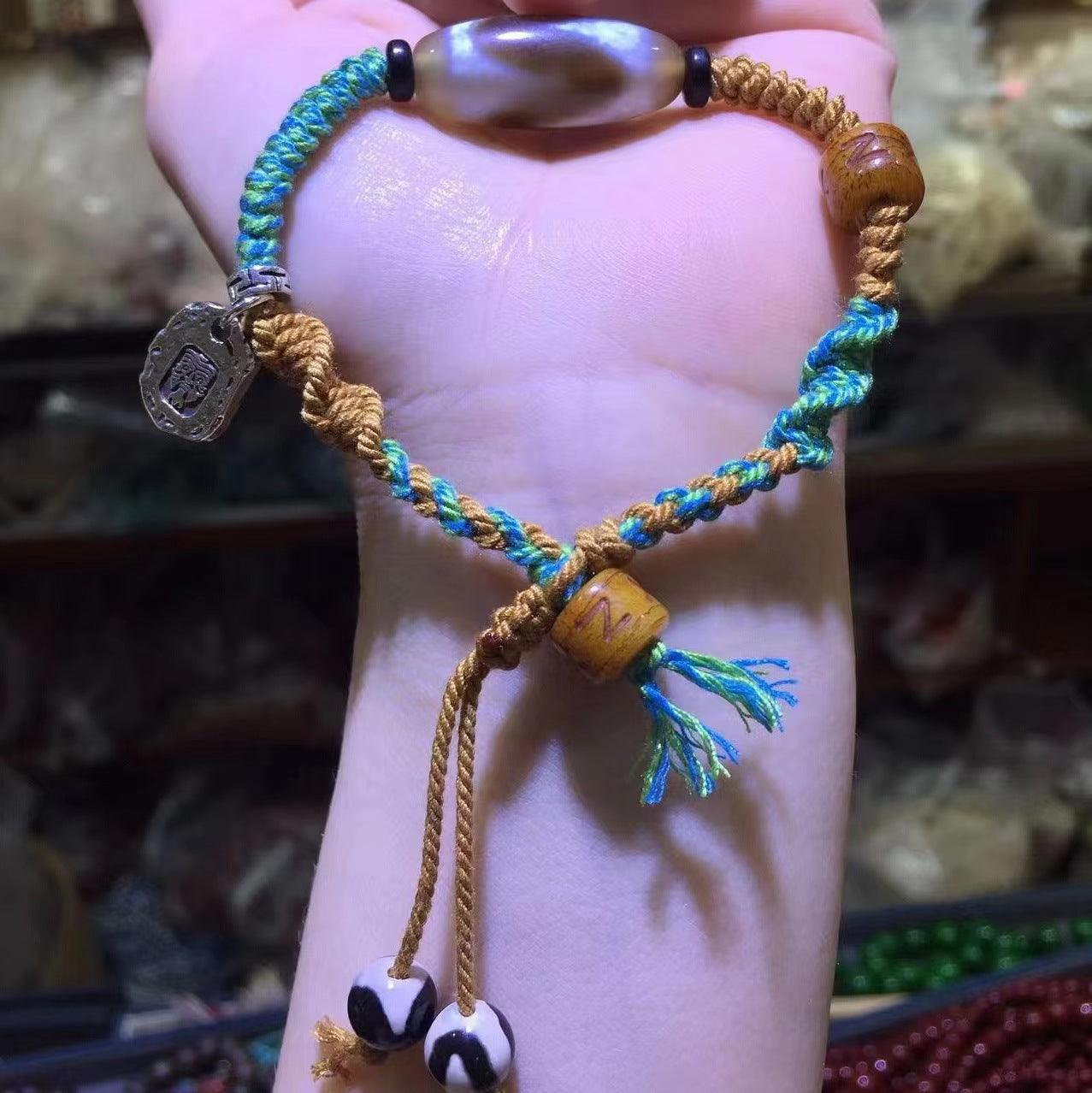 Close-up of the braided green and brown cord, showcasing the intricate craftsmanship and texture.