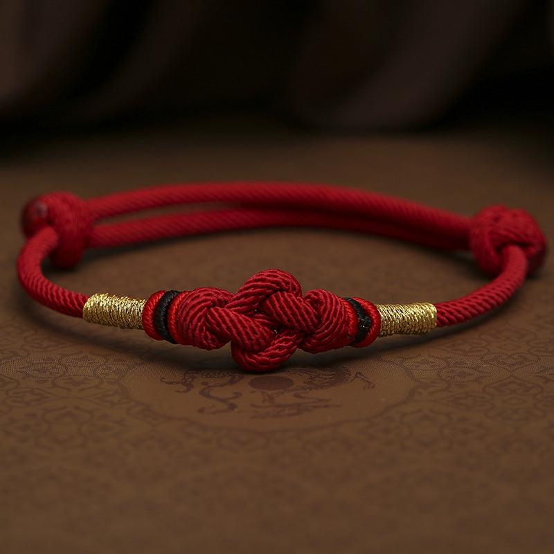 Close-up of the detailed knotting on the red rope, showcasing the craftsmanship and symbolic meaning of unity and strength.