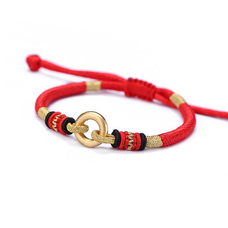 Close-up of the gold ring and intricate woven details on the red cord, adding elegance and Tibetan cultural symbolism.