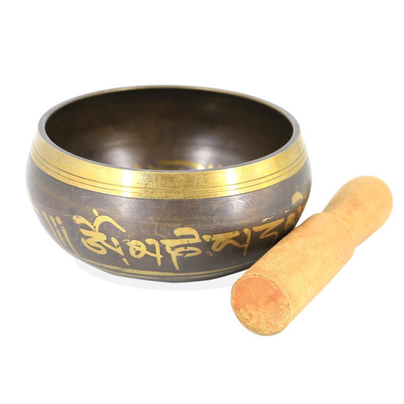 Close-up of the golden Tibetan inscriptions on the Singing Bowl, emphasizing spiritual resonance.