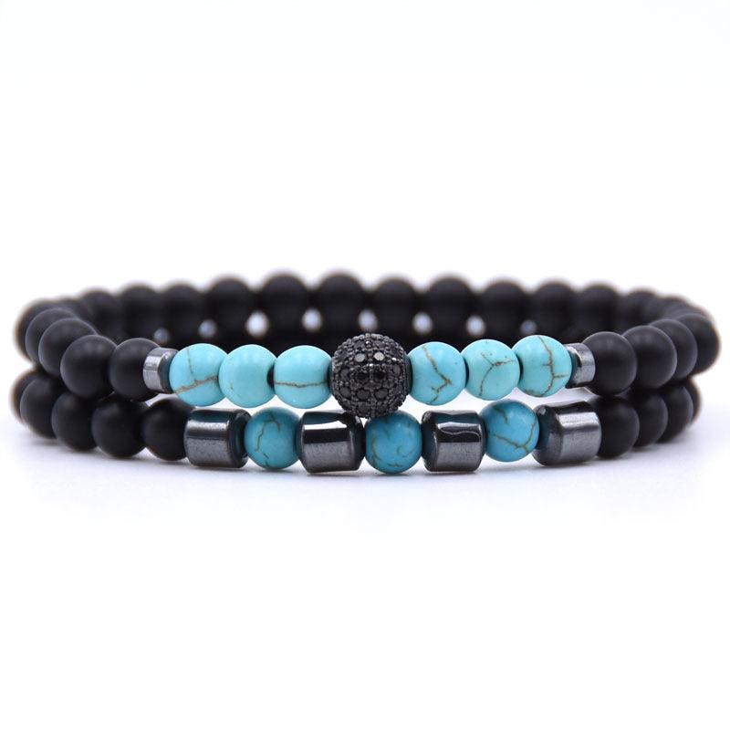 Close-up of the turquoise and black beads, showcasing the smooth turquoise patterns and matte black finish.