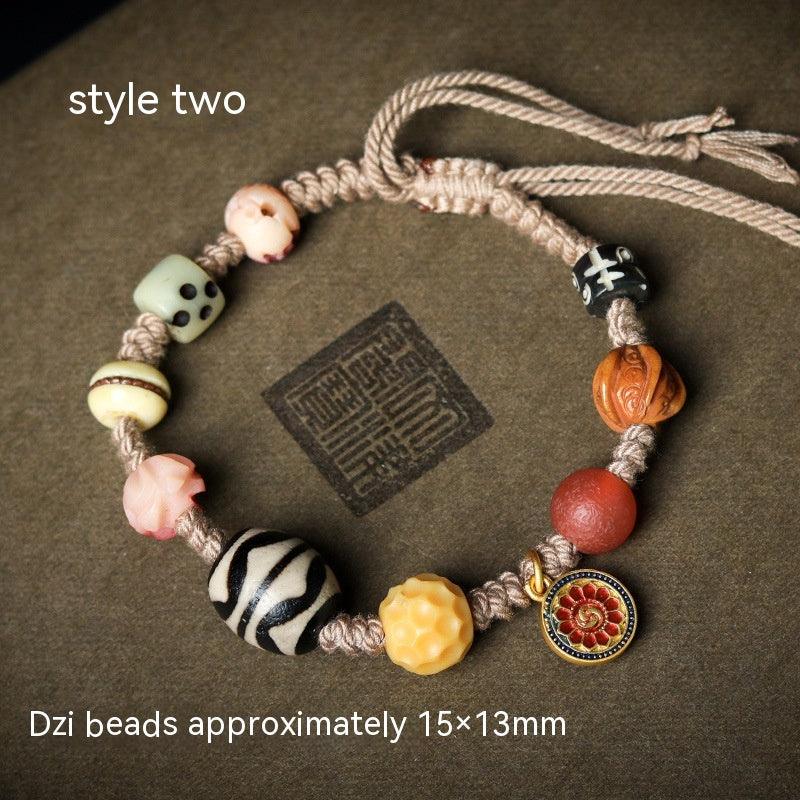 Close-up of zebra-patterned Dzi bead, representing strength and spiritual guidance.