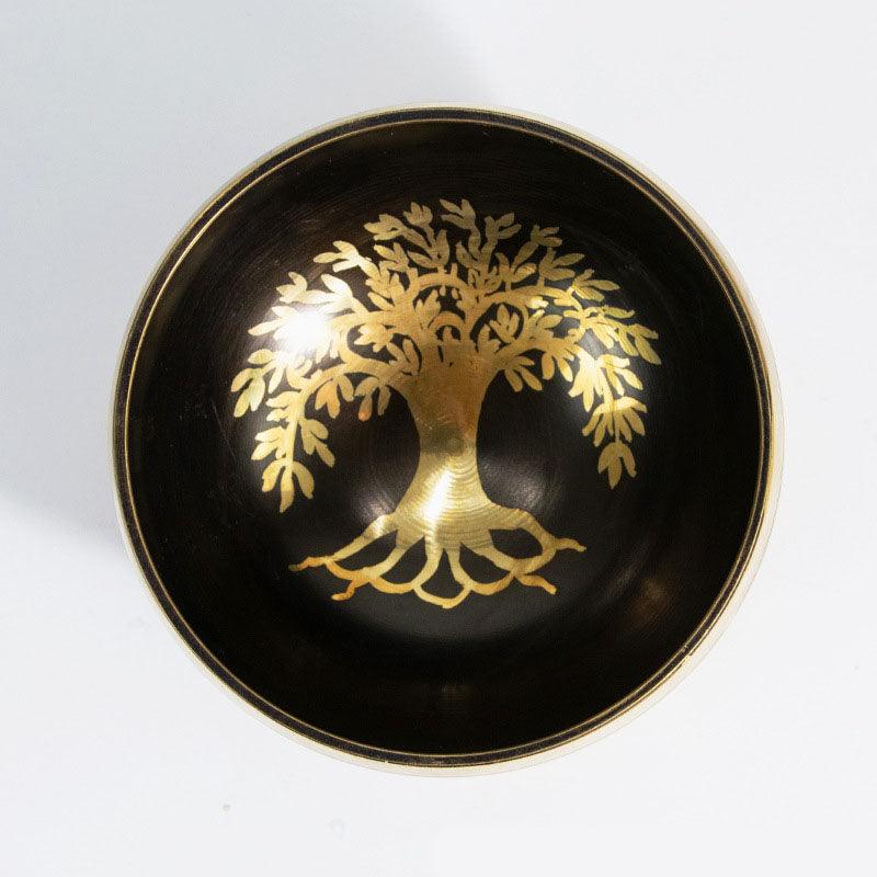 Decorative Tibetan singing bowl featuring the Tree of Life, often associated with Buddhist and Hindu beliefs in eternal life and interconnectedness.