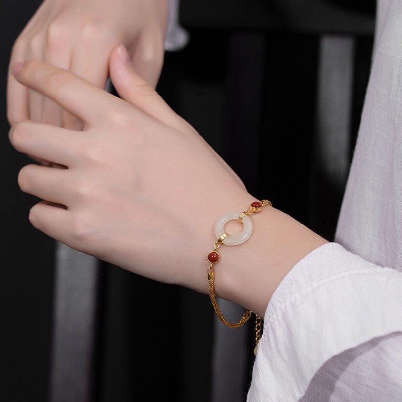 Delicate white jade bracelet adorned with golden accents, perfect for a timeless and graceful look.
