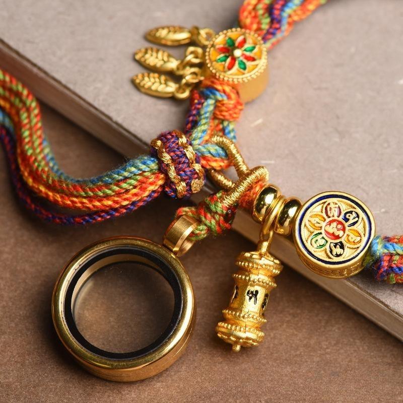 Detailed shot of the Tibetan prayer wheel charm, symbolizing spiritual guidance and positive energy.