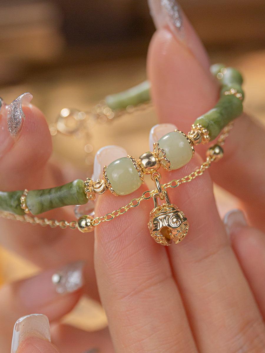 Detailed shot of the bracelet’s jade beads and gold chain, showing the exquisite craftsmanship.