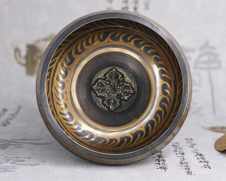 Detailed shot of the golden script on the Tibetan Singing Bowl, representing blessings and harmony in Tibetan culture.