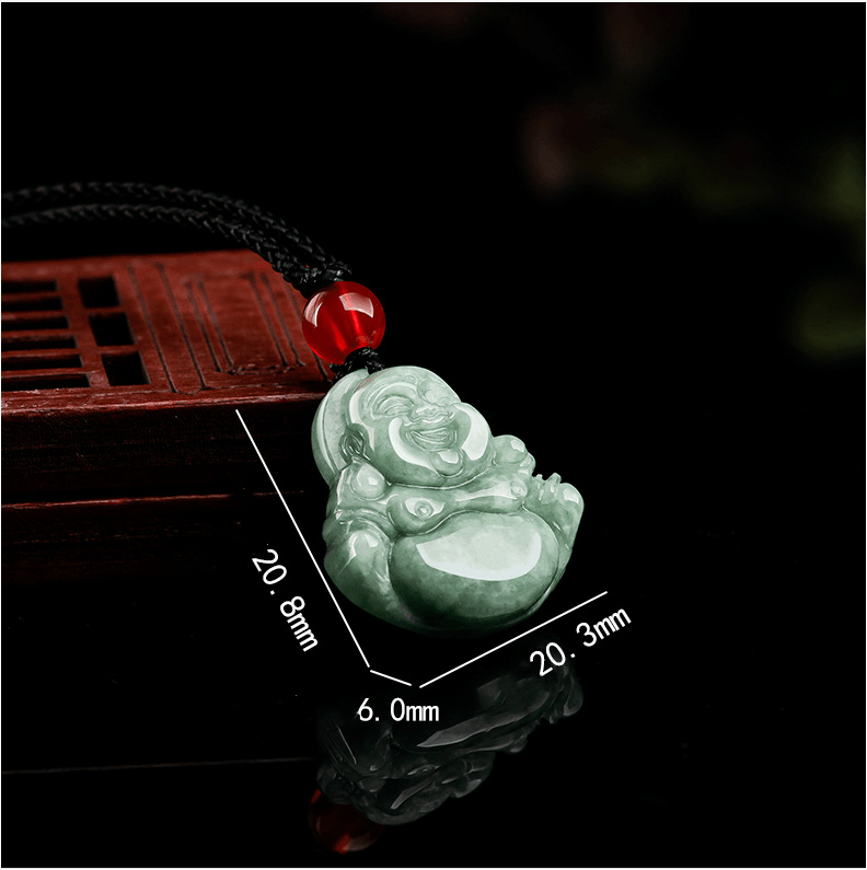 Detailed view of the jade pendant’s red bead and Buddha carving, symbolizing protection and joy.