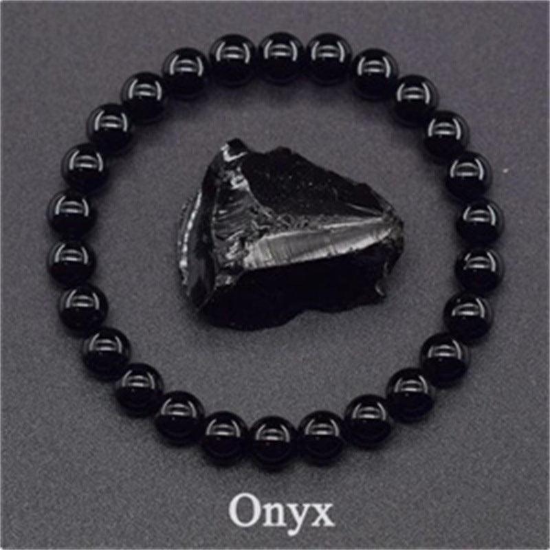 Detailed shot of the onyx beads, capturing the smooth, glossy surface that embodies emotional stability.