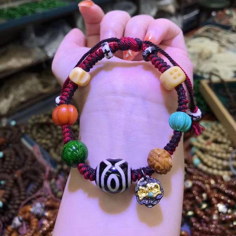 Detailed shot of the red braided cord with colorful beads, adding a lively and vibrant look.