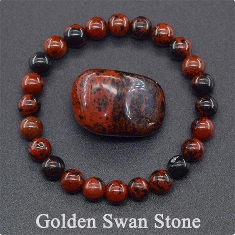 Detailed view of the Golden Swan Stone bracelet, capturing its deep colors and grounding energy.