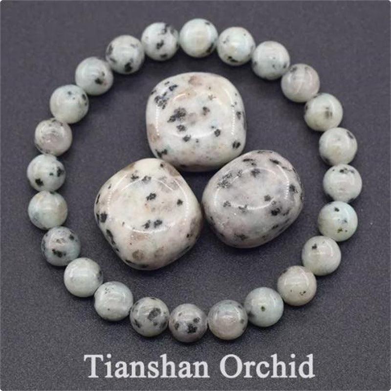 Detailed view of the Tianshan Orchid bracelet, showcasing the soft white base with delicate black patterns that embody purity and balance.