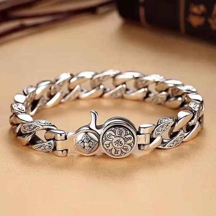 Close-up of patterned metal links on rotating mantra bracelet