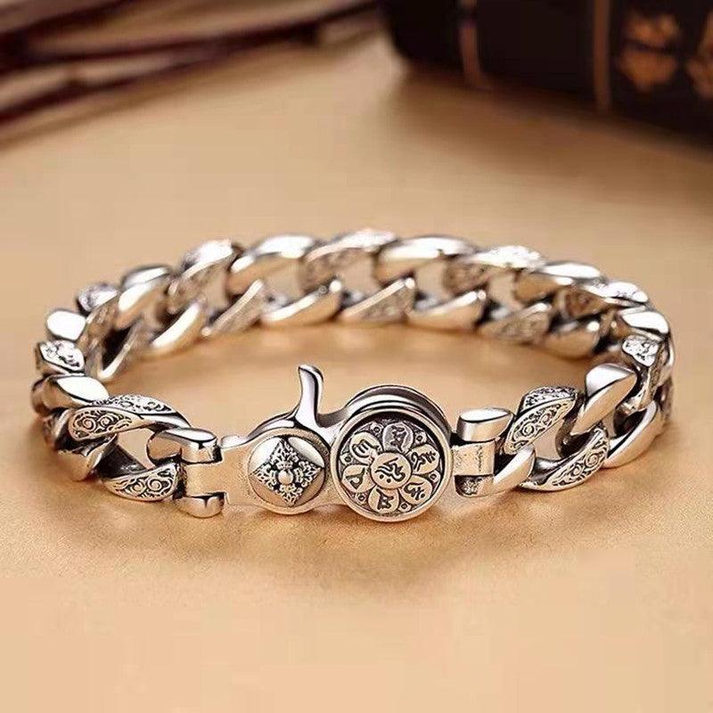 Close-up of patterned metal links on rotating mantra bracelet
