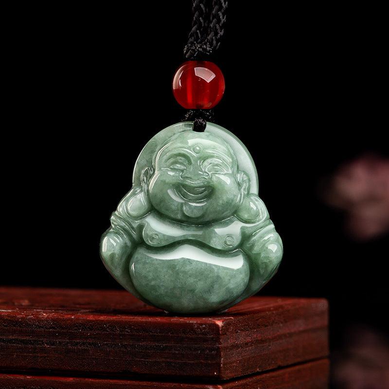 Detailed view of the jade pendant’s red bead and Buddha carving, symbolizing protection and joy.