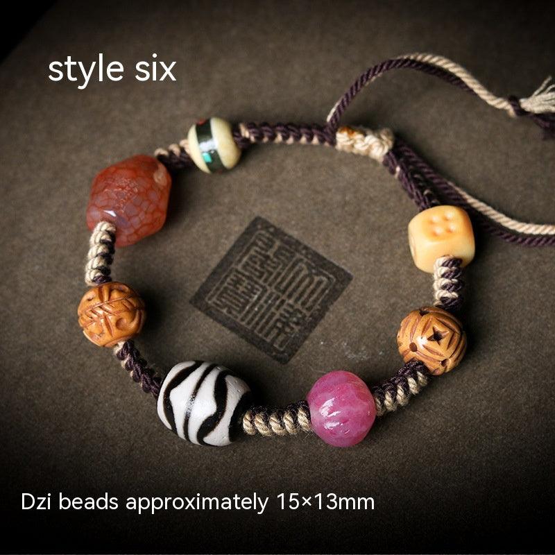Detailed view of the pink bead paired with other beads, highlighting the bracelet’s harmonious color palette.