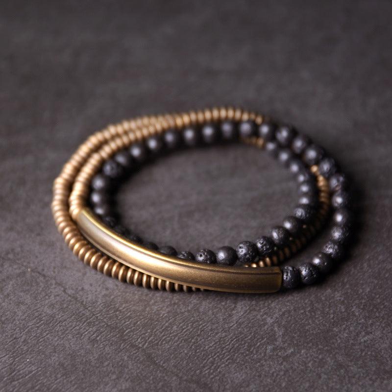 Double-layered bracelet with black obsidian beads and brass accents, offering balance and style.