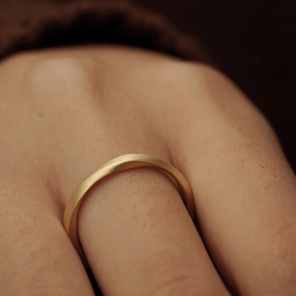 Elegant gold band ring with a minimalist design, perfect for adding subtle sophistication.