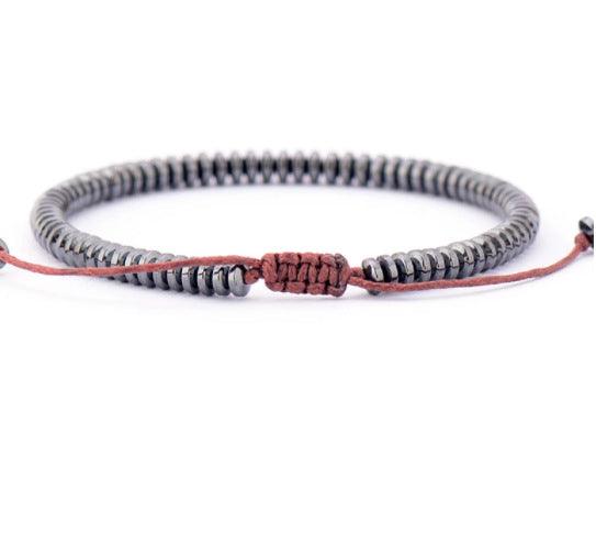 Elegant gunmetal Tiger Eye stone bracelet, showcasing uniform beads that reflect the wearer’s inner strength and clarity. The metallic black tone adds a refined touch, ideal for daily wear.