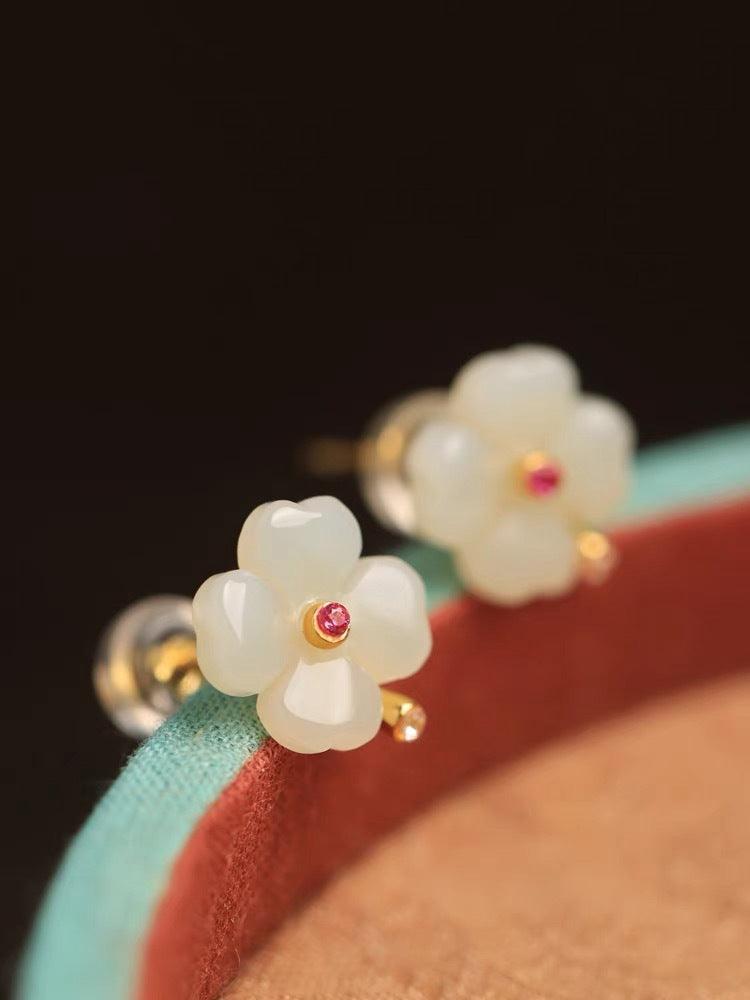 Elegant jade earrings in the shape of a four-petal flower, combining jade’s purity with the charm of red gemstone accents.