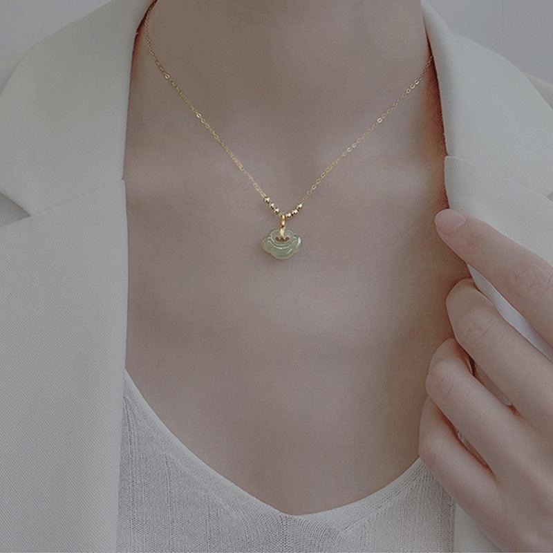Elegant jade pendant necklace in soft green, shown gracefully on the neck, symbolizing serenity, protection, and balance.