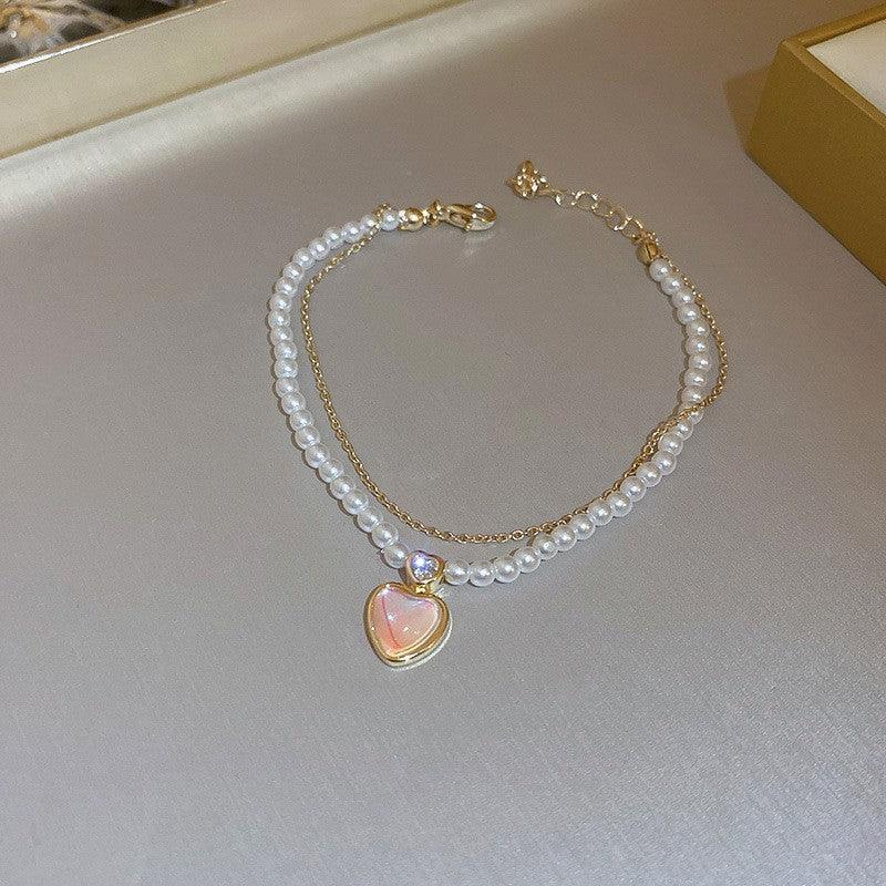 Elegant opal and crystal pearl necklace with a heart pendant, adding a touch of romance and sophistication.