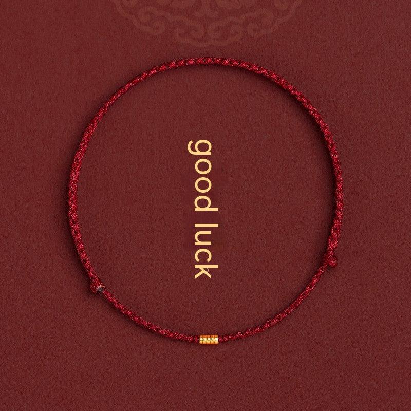 Red braided cord bracelet with small gold-tone beads