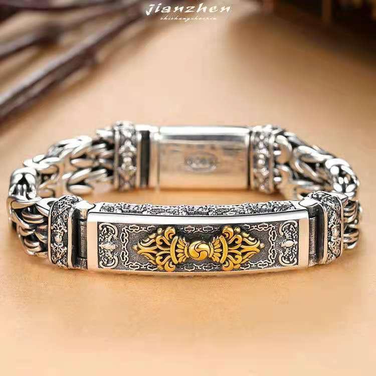 Elegant silver bracelet with intricate gold accents and traditional patterns, symbolizing prosperity and elegance.