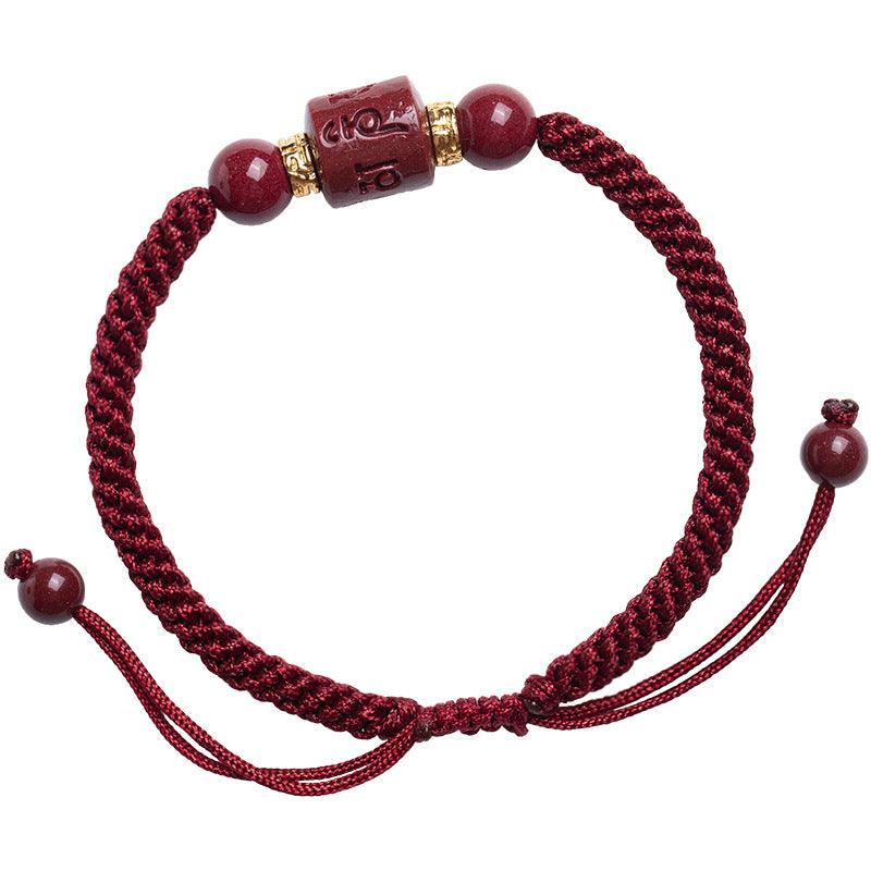 Elegant vermilion red string bracelet with a cinnabar Six-Word Mantra bead at its center, offering balance and spiritual protection to the wearer.