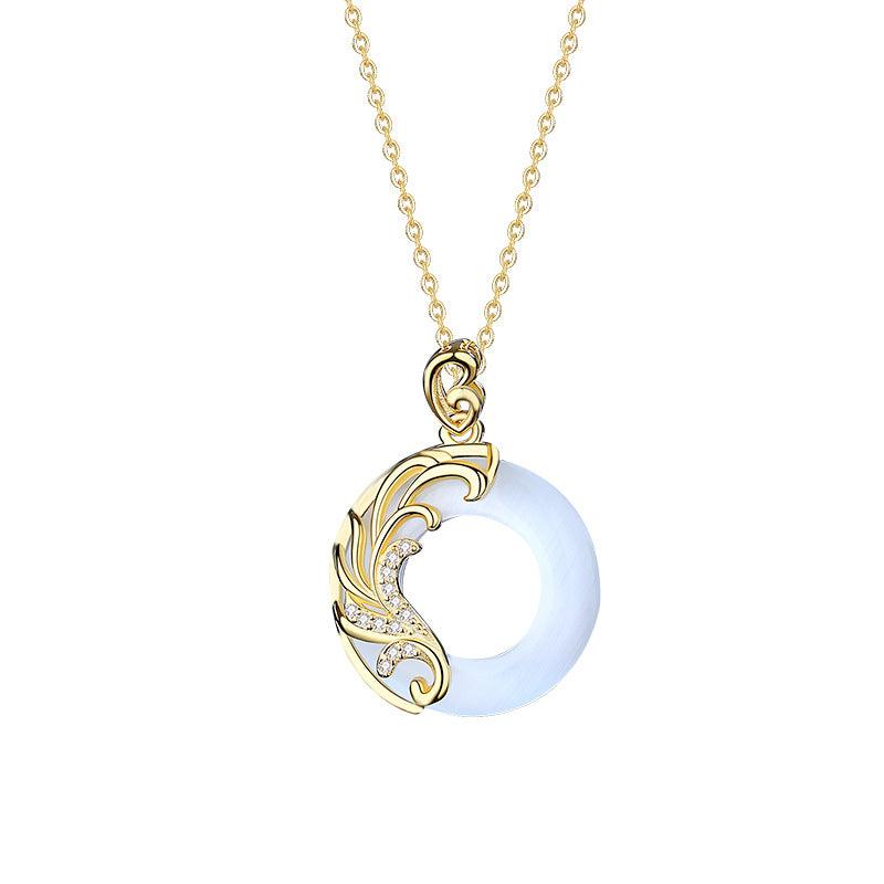 Elegant white circular pendant with golden filigree detailing, symbolizing purity and grace, ideal for those seeking a refined and classic necklace design.