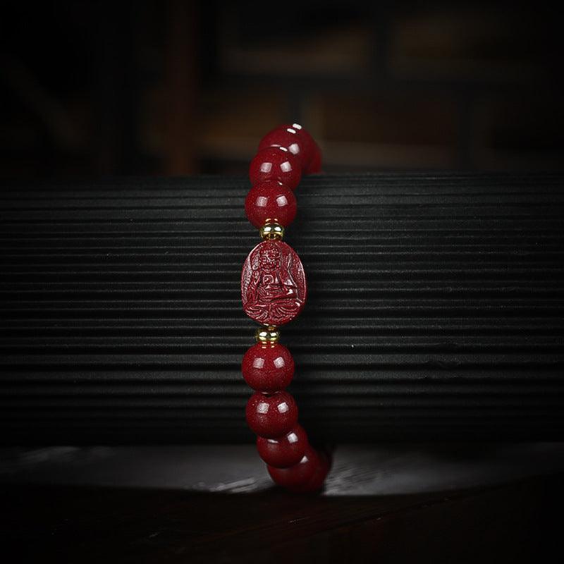 Fine details of the cinnabar bracelet and Buddha carving, showcasing artisanal quality and spiritual depth.